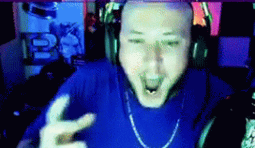 A Bald Man Wearing Headphones And A Blue Shirt Is Making A Peace Sign GIF