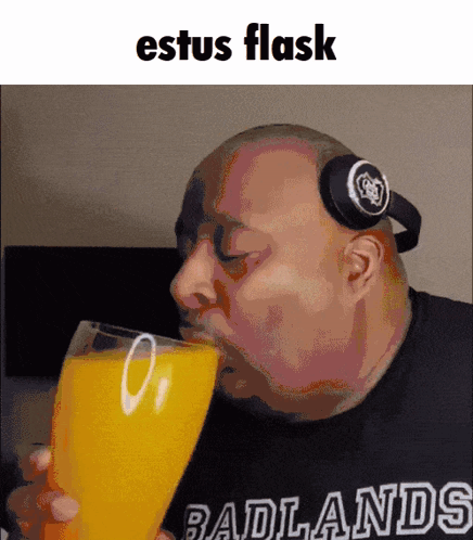 Bald Man With Headphones Drinking Orange Juice GIF