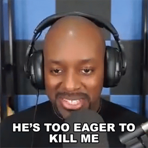 A Bald Man Wearing Headphones Is Talking Into A Microphone And Saying He 'S Too Eager To Kill Me . GIF