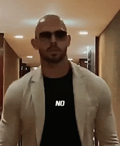 A Bald Man Wearing Sunglasses And A Black Shirt That Says No GIF