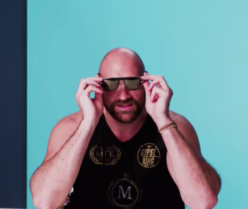 A Bald Man Wearing Sunglasses Has A Shirt That Says Gypsy King On It GIF