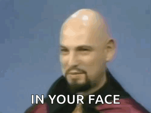 A Bald Man With A Beard And A Ring On His Finger Is Making A Devil Horns Sign With His Hands . GIF