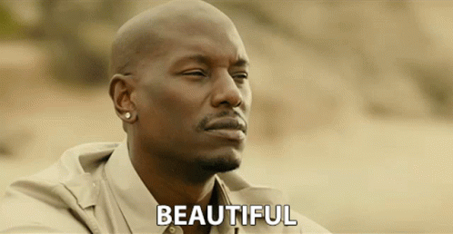 A Bald Man With A Beard And Earrings Says Beautiful GIF