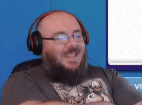 A Bald Man With A Beard And Glasses Is Wearing Headphones . GIF