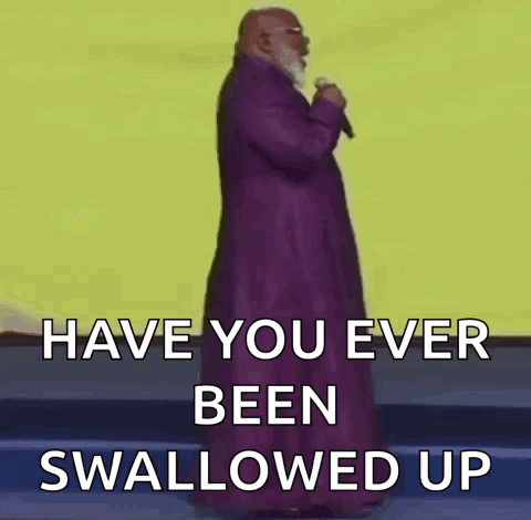 A Bald Man With A Beard Is Holding A Microphone And Says `` Have You Ever Been Swallowed Up '' . GIF