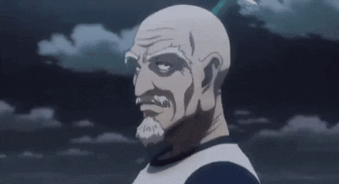 A Bald Man With A Beard Is Holding His Hand To His Chin And Looking At The Camera . GIF