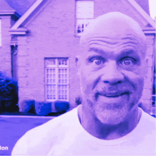 A Bald Man With A Beard Is Smiling In Front Of A House GIF