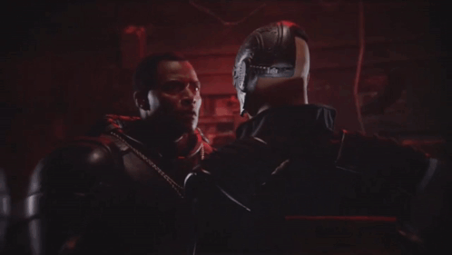 A Bald Man With A Beard Is Smiling In Front Of Another Bald Man GIF