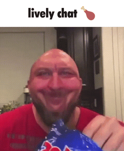 A Bald Man With A Beard Is Smiling While Holding A Bag Of Chicken GIF