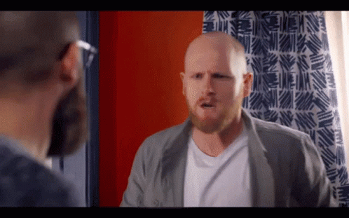 Bald Man With Beard In Front Of Blue White Curtain GIF