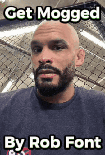 A Bald Man With A Beard Is Standing In Front Of A Chain Link Fence With The Caption Get Mogged By Rob Font GIF