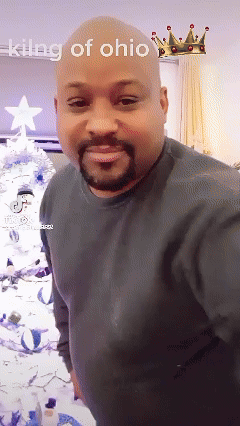 A Bald Man With A Beard Is Standing In Front Of A Christmas Tree With The Words King Of Ohio Above Him GIF