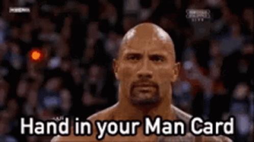 A Bald Man With A Beard Is Standing In Front Of A Crowd . GIF