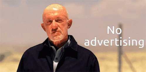 A Bald Man With A Beard Is Standing In Front Of A Sign That Says No Advertising GIF