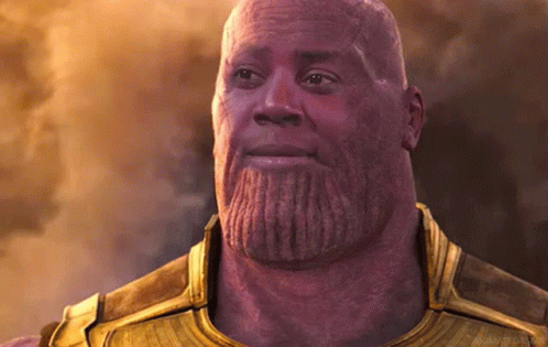 A Bald Man With A Beard Is Wearing A Gold Armor .. GIF