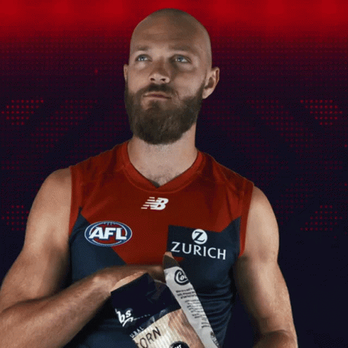 A Bald Man With A Beard Is Wearing An Afl Jersey With Zurich On It GIF