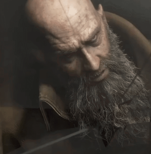 A Bald Man With A Beard Looks At Something GIF