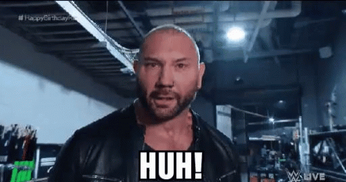 A Bald Man With A Beard Wearing A Black Leather Jacket Is Making A Funny Face . GIF