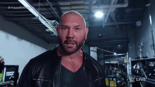 A Bald Man With A Beard Wearing A Leather Jacket GIF