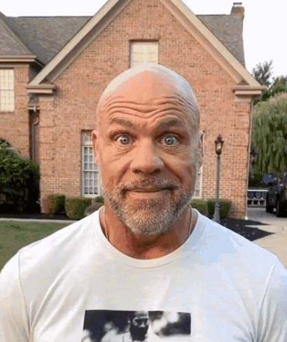 A Bald Man With A Beard Wearing A White Shirt GIF