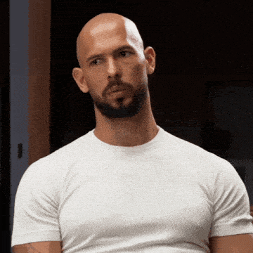 A Bald Man With A Beard Wearing A White T-Shirt GIF