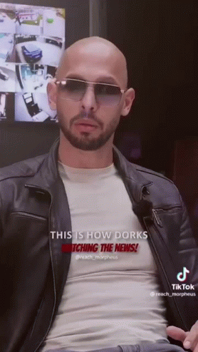 A Bald Man With A Beard Wearing Sunglasses And A Leather Jacket Says This Is How Dorks Watching The News GIF