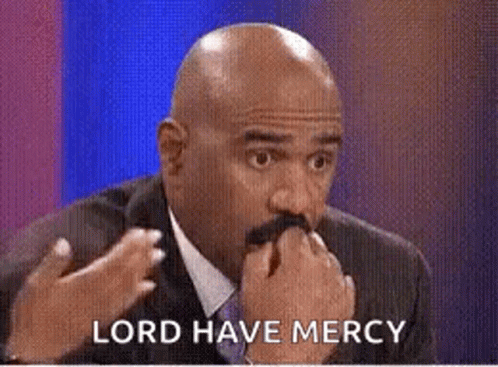 A Bald Man With A Mustache Is Holding His Hand To His Mouth While Talking . GIF