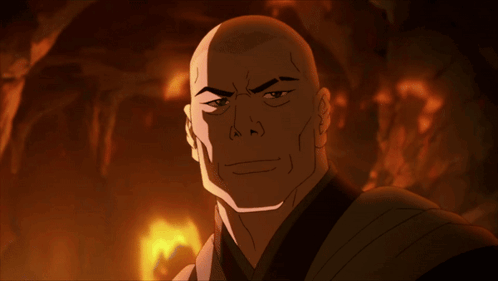 A Bald Man With A Serious Look On His Face Is Standing In Front Of A Fire GIF