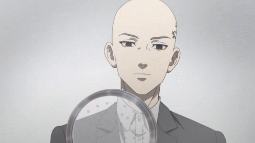 A Bald Man With A Tattoo On His Forehead Is Holding A Magnifying Glass GIF