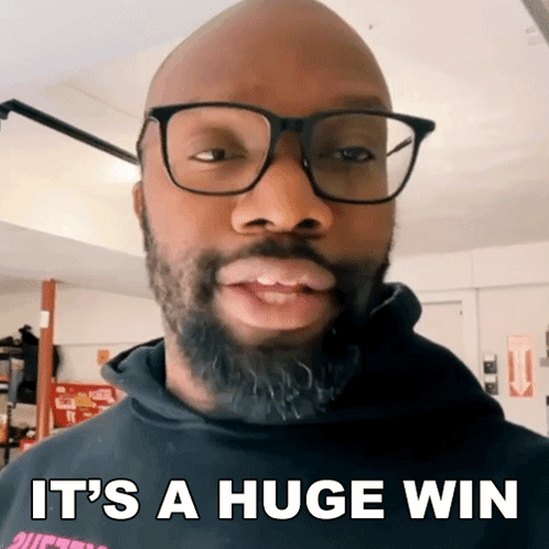 A Bald Man With Glasses And A Beard Is Saying It 'S A Huge Win GIF
