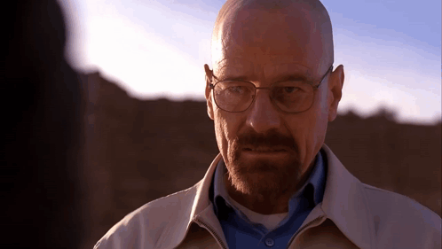 A Bald Man With Glasses And A Beard Looks At Someone GIF
