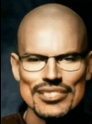 A Bald Man With Glasses And A Mustache Is Smiling And Looking At The Camera . GIF