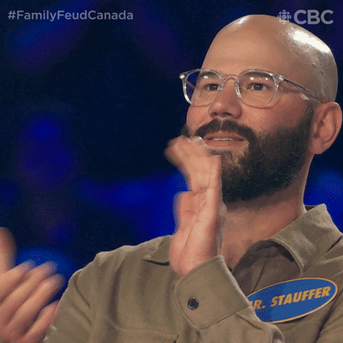 A Bald Man With Glasses And A Name Tag That Says R. Stauffer Clapping His Hands GIF