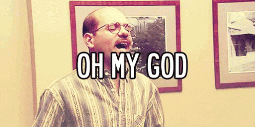 A Bald Man With Glasses Says Oh My God In Front Of Framed Pictures GIF
