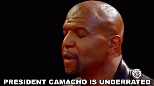 A Bald Man With His Eyes Closed And The Words President Camacho Is Underrated Above Him GIF