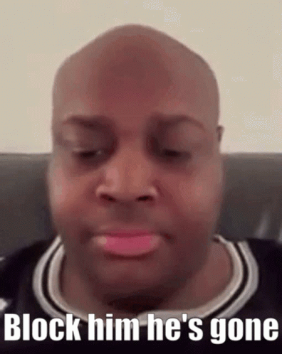 A Bald Man With Pink Lipstick On His Lips Is Sitting On A Couch And Says Block Him He 'S Gone . GIF