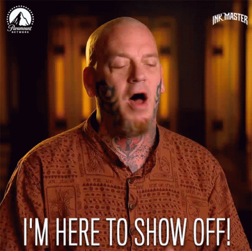 A Bald Man With Tattoos On His Face Says I 'M Here To Show Off GIF