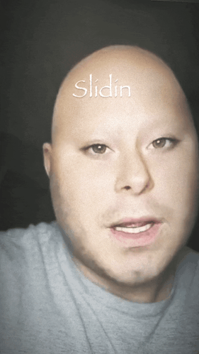 A Bald Man With The Word Slidin Written On His Head GIF