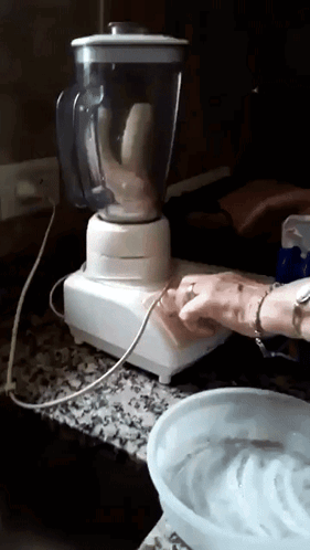 A Banana Is Being Blended In A Blender On A Counter Top GIF