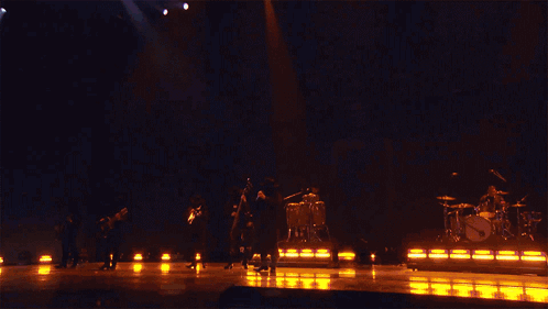 A Band Performing On Stage With A Sign That Says Fuerza Regida GIF