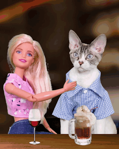 a barbie doll and a cat are sitting at a table with a glass of wine and a mug of beer