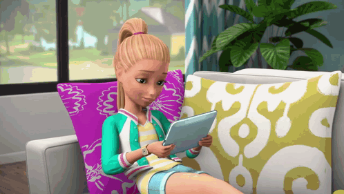 A Barbie Doll Is Sitting On A Couch Using A Tablet Computer GIF