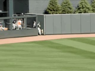 A Baseball Field With A Fence And A Player Wearing A Number 1 Jersey GIF