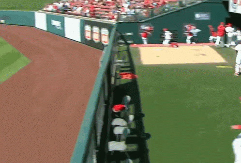 A Baseball Field With A Fence And A Sign That Says ' Angels ' On It GIF
