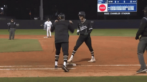 A Baseball Game Is Being Played At Russ Chandler Stadium With A Coca Cola Ad On The Scoreboard GIF