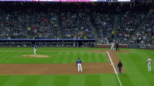 A Baseball Game Is Being Played In A Stadium With A Sign That Says ' Coca Cola ' On It GIF