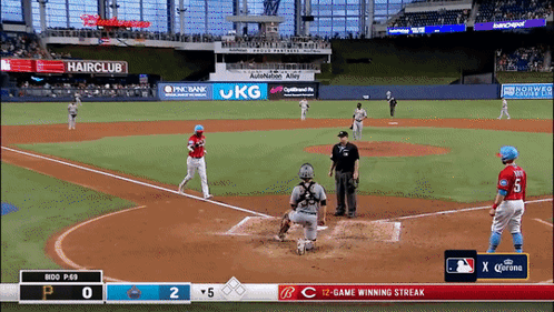 A Baseball Game Is Being Played In A Stadium With Ads For Hairclub And Jkg GIF