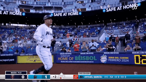 A Baseball Game Is Being Played In A Stadium With Advertisements For Safe At Home And Home Of Beisbol GIF