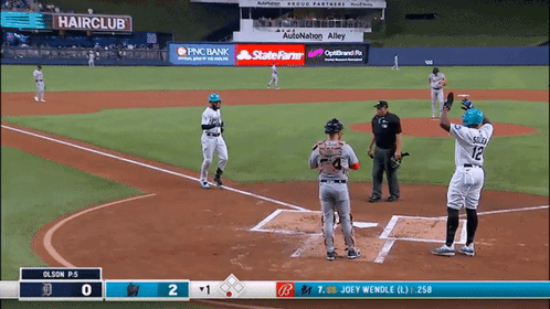 A Baseball Game Is Being Played In A Stadium With An Ad For Hairclub GIF