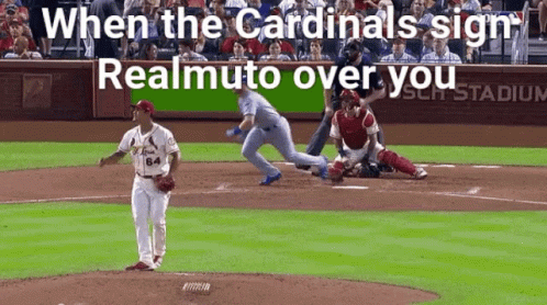 A Baseball Game Is Being Played In A Stadium With The Words " When The Cardinals Sign Realmuto Over You " On The Screen GIF